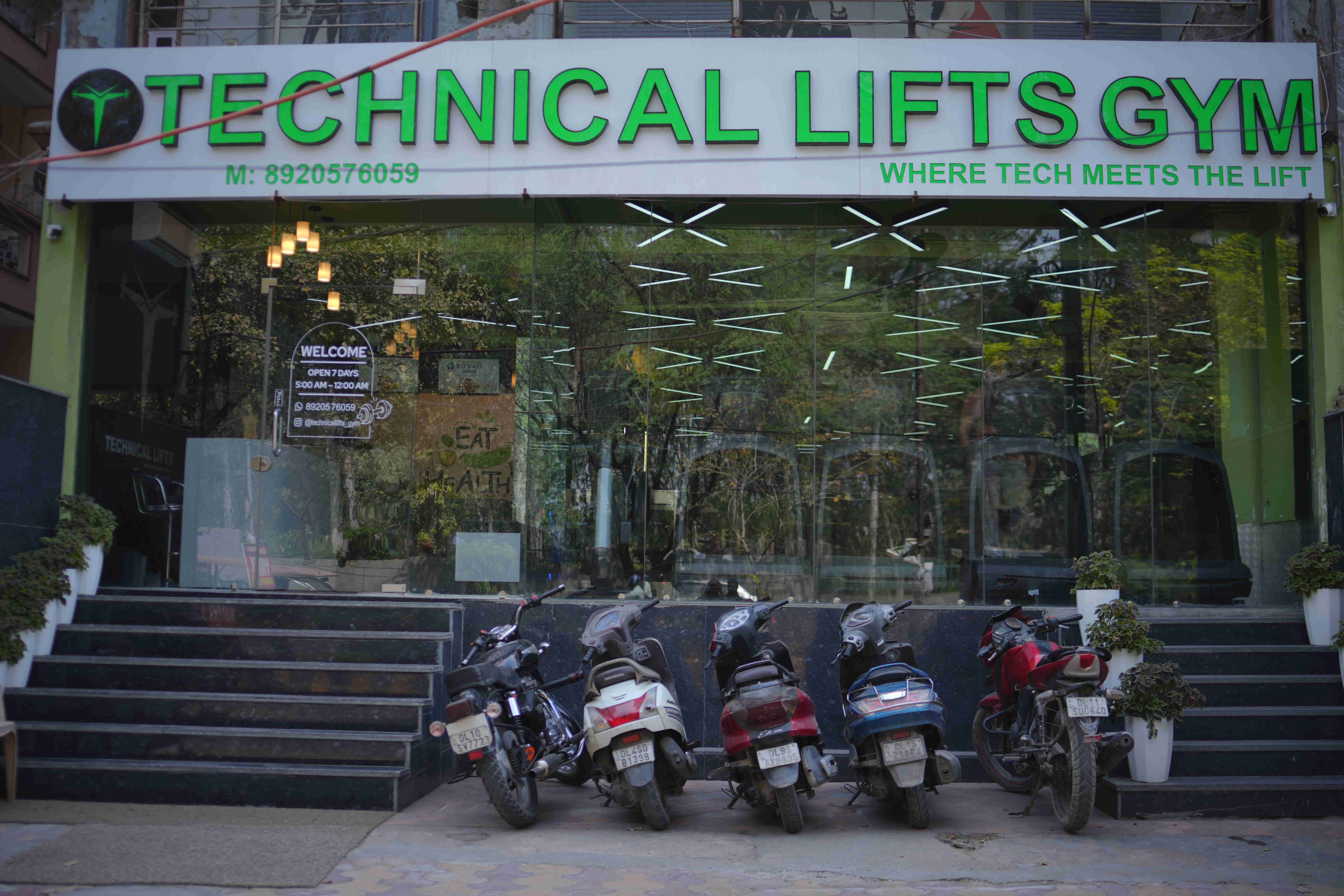 Member holding dumbbells in gym